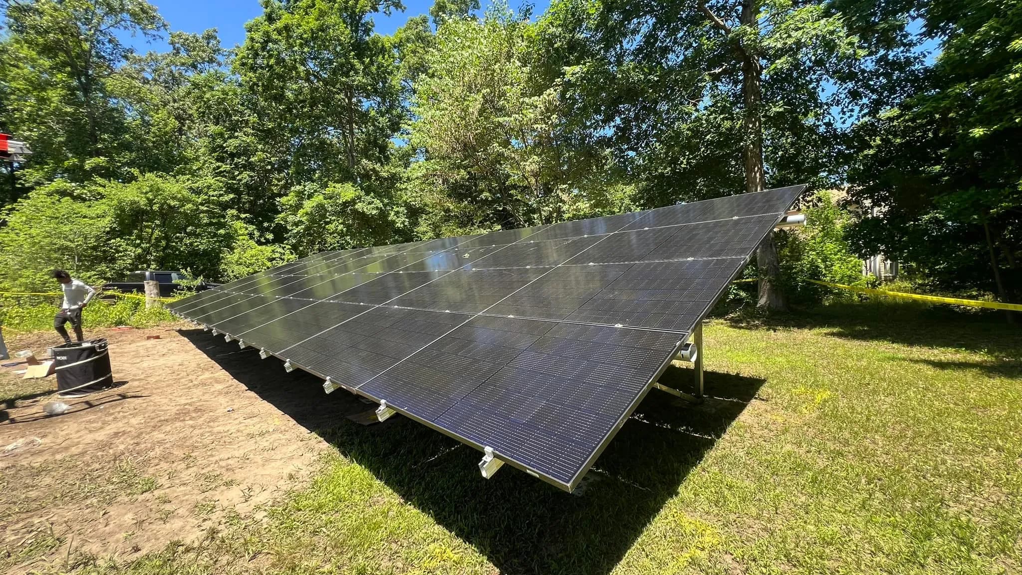 Solar panels installed on red metal roof barn structure